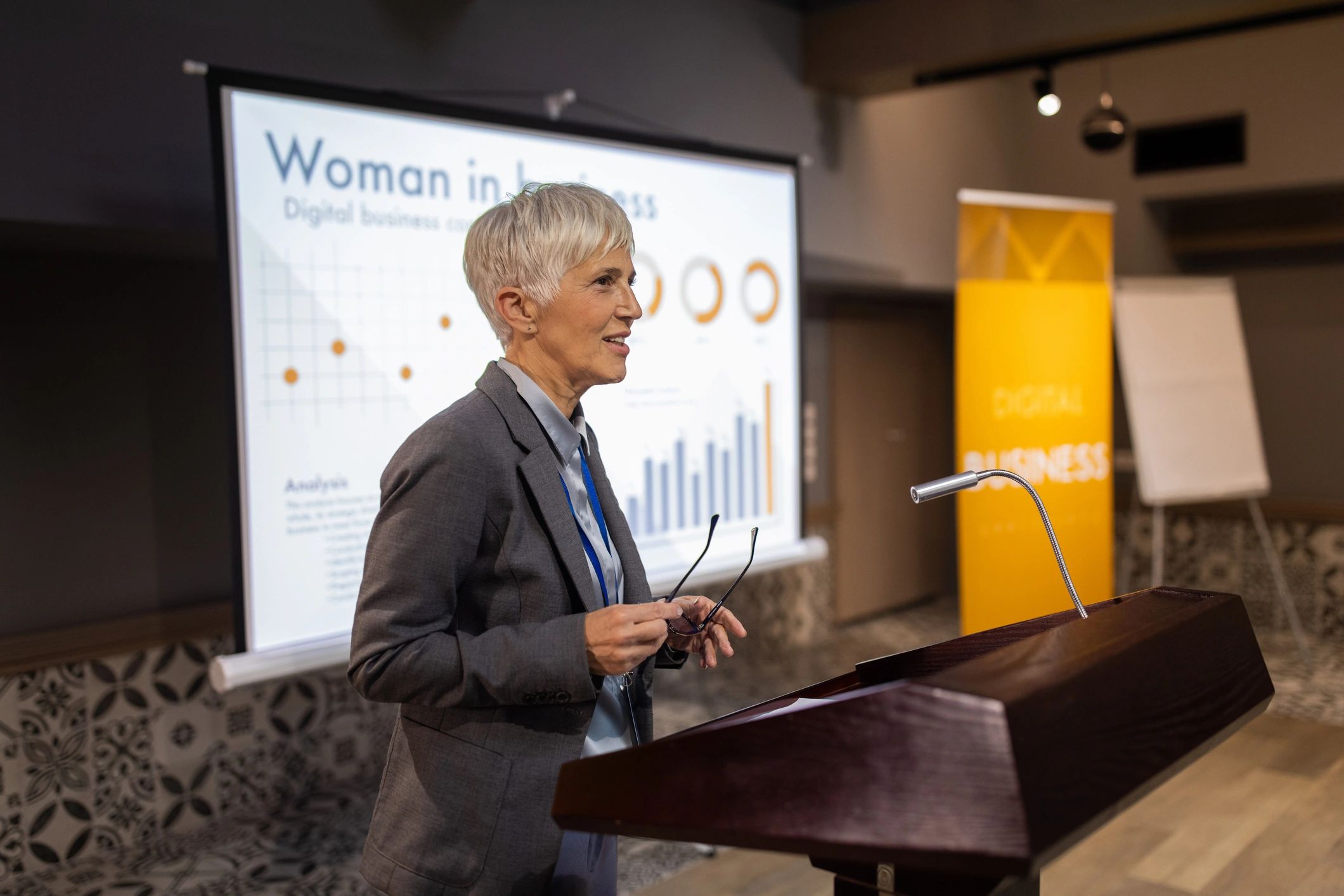 Speaker presenting at a podium in a conference room