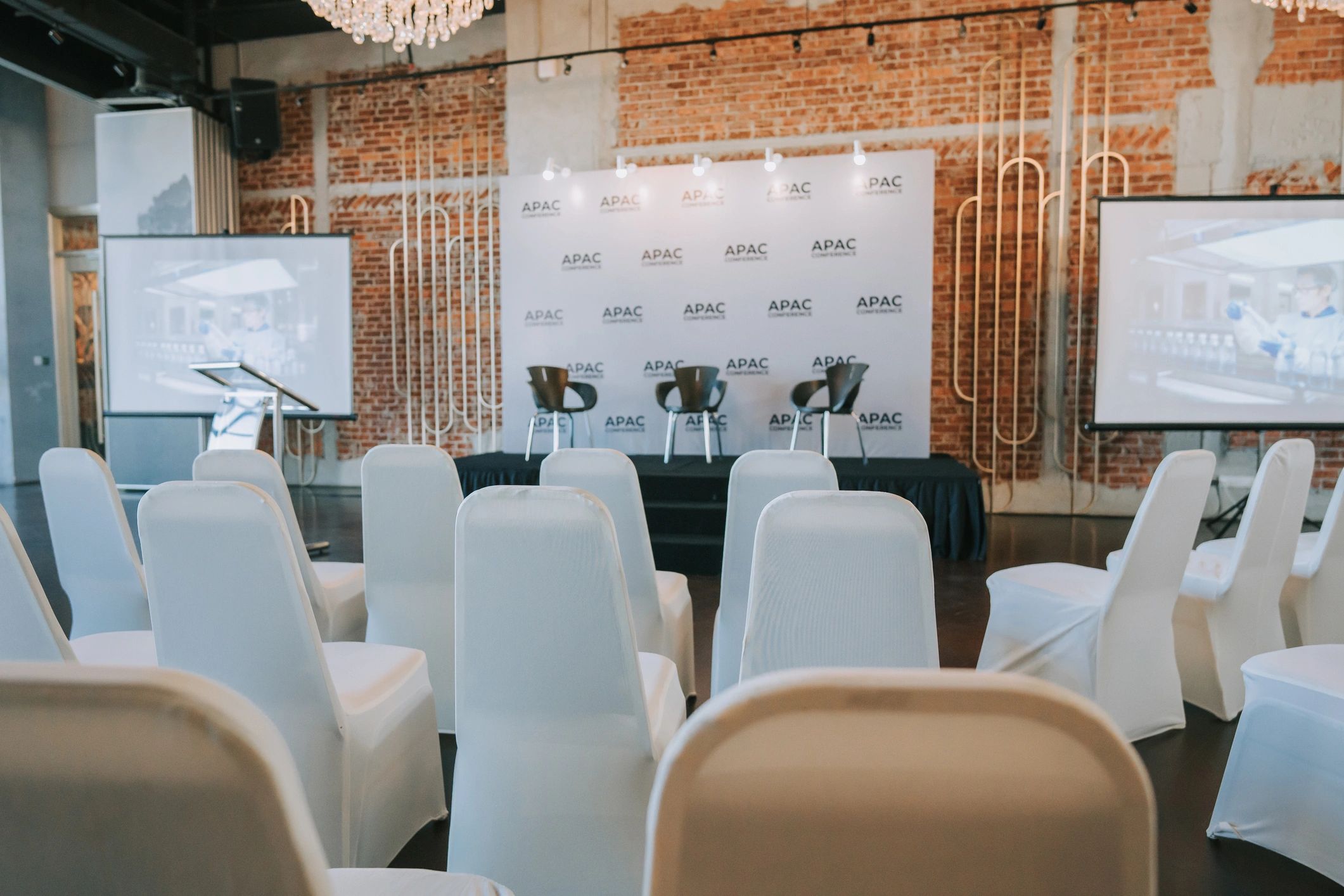 Conference stage with podium, screen, and seating