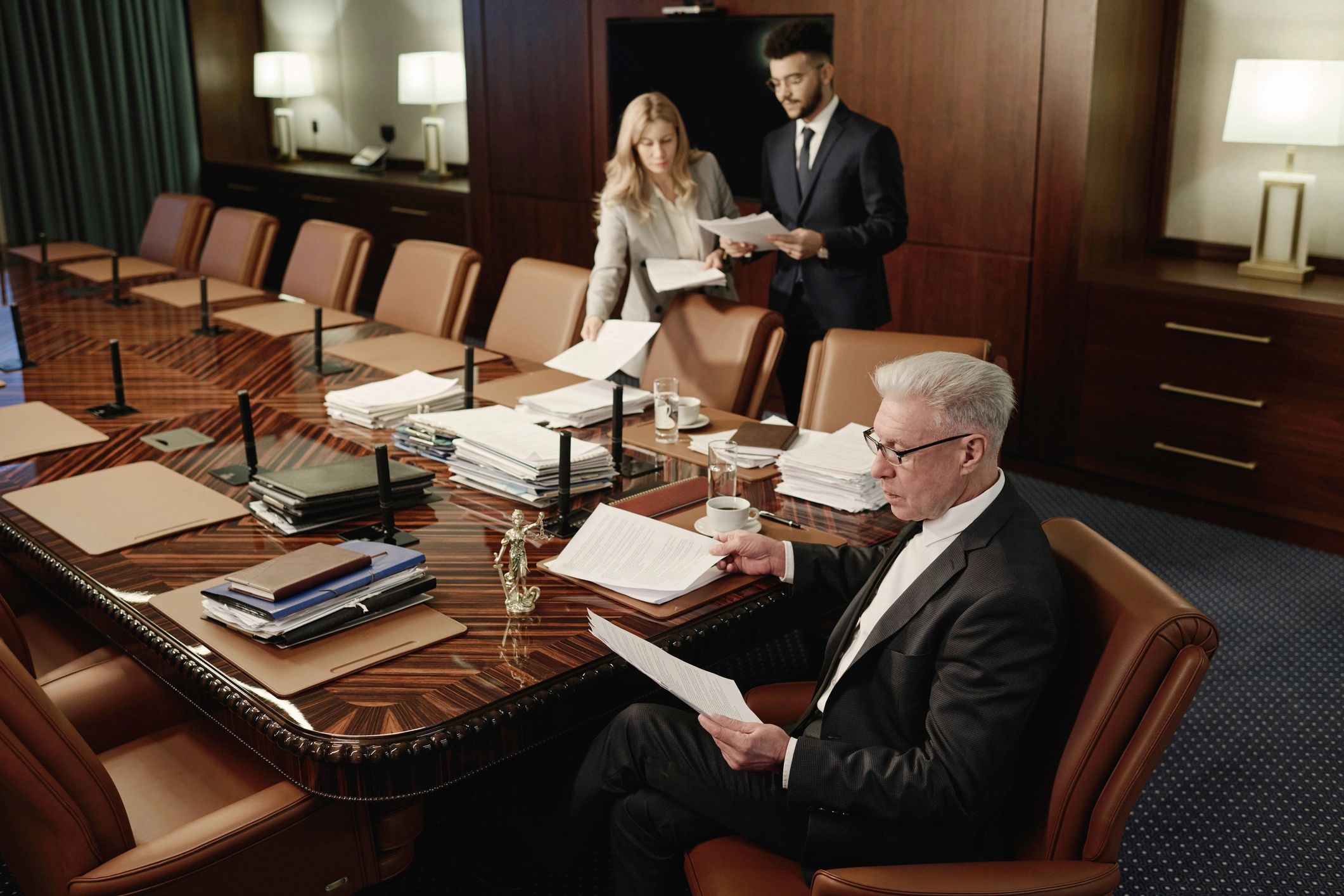 Conference participants reviewing documents together in a meeting room