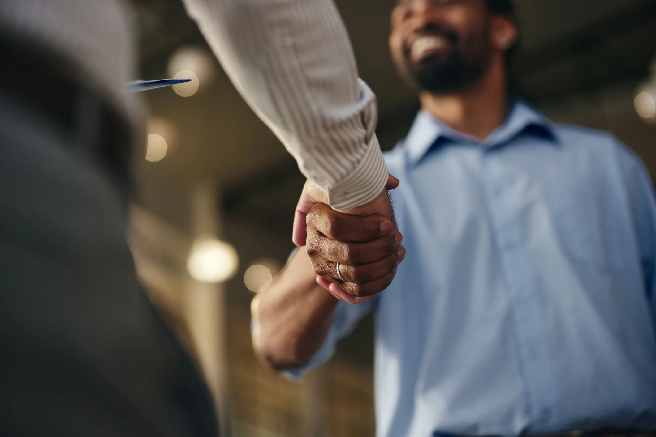 Close-up of a professional handshake representing trust and confidentiality