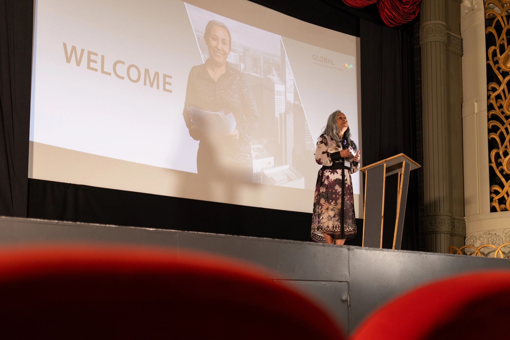 Keynote speaker presenting on stage at a conference