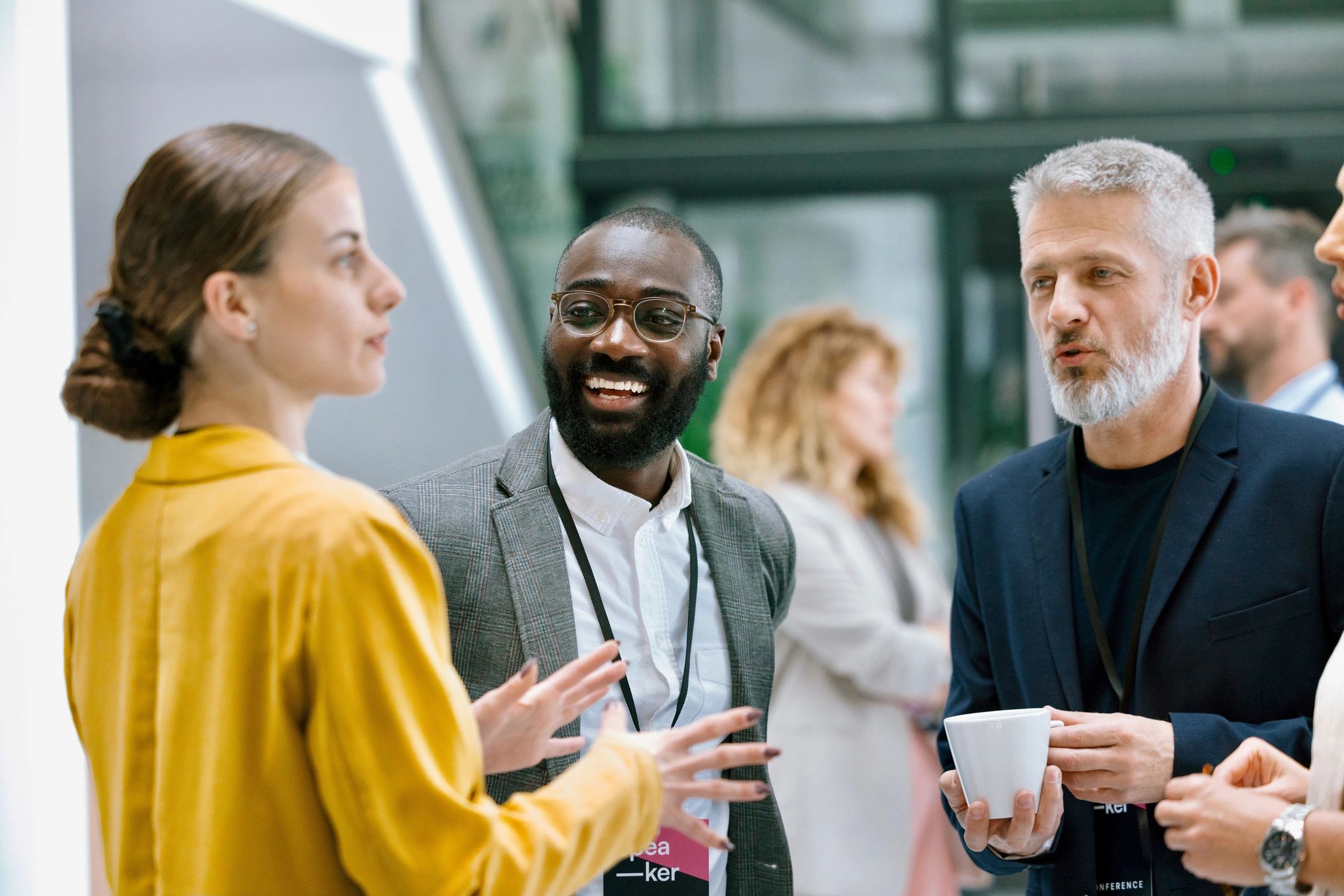 Colleagues conversing during a conference intermission