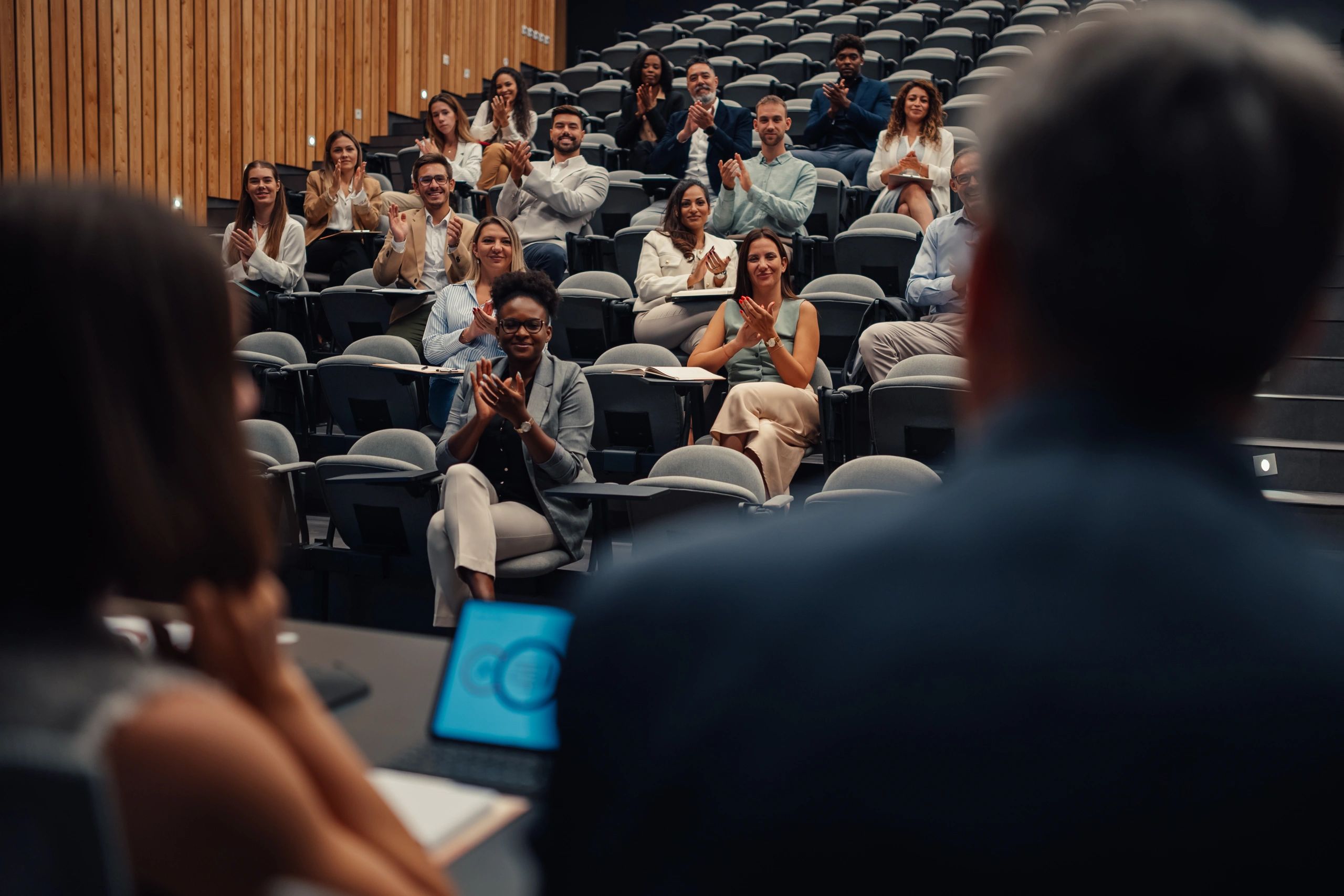 Conference audience applauding during a presentation