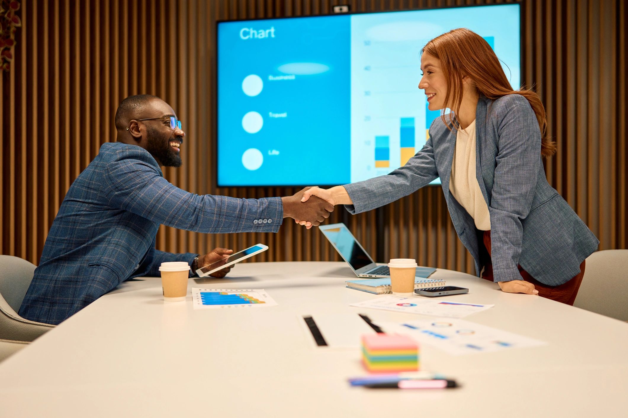 Two professionals shaking hands after a successful meeting