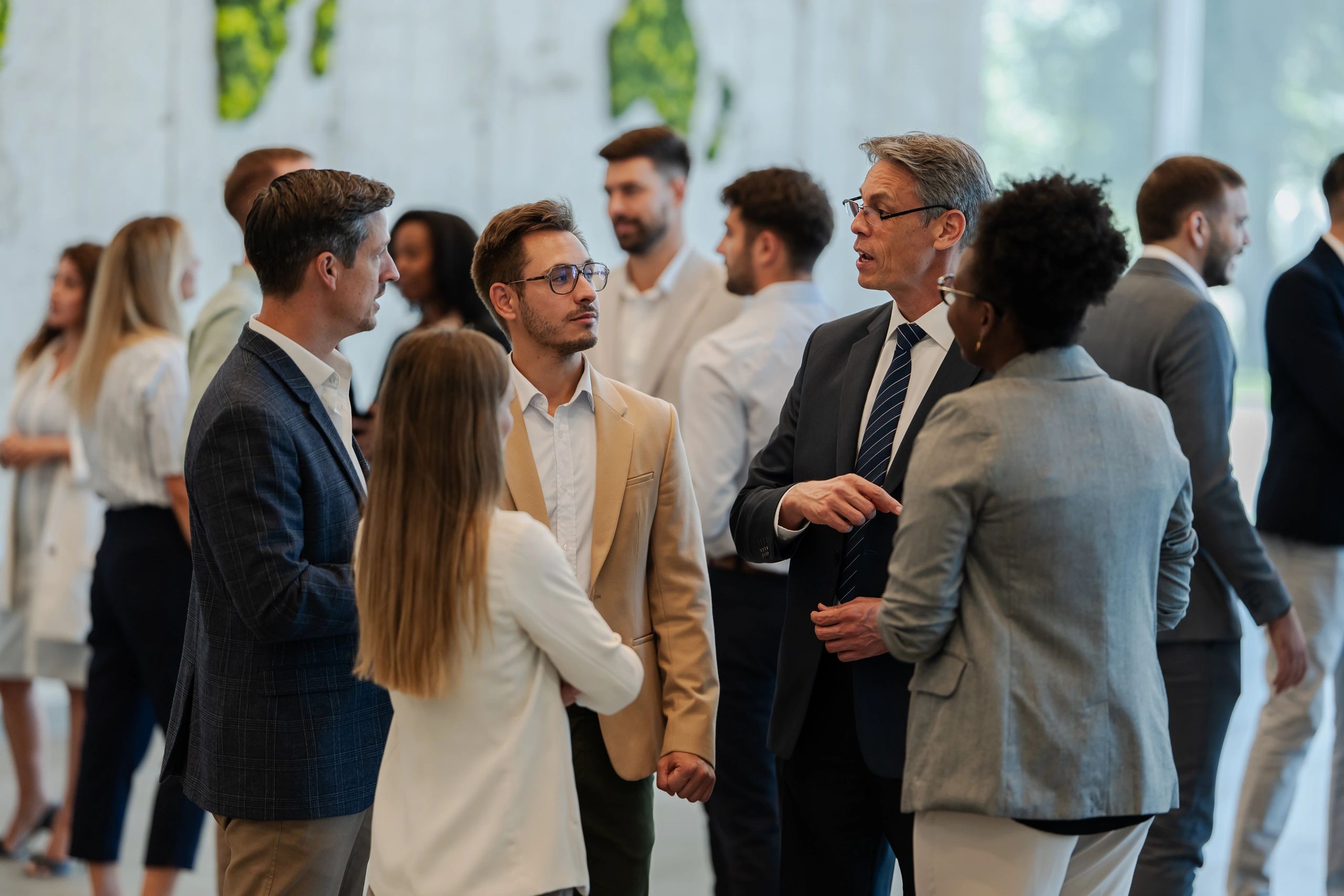 Professionals networking at a conference reception